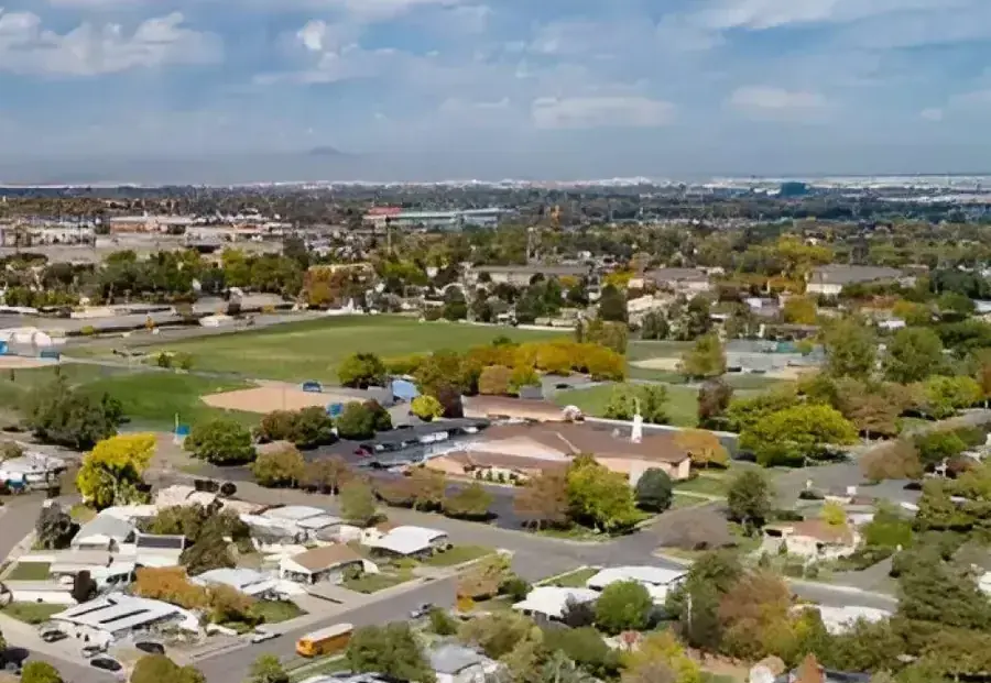 Aerial view of homes, ball fields and tree-lined streets on the valley floor, typical of Riverton neighborhoods