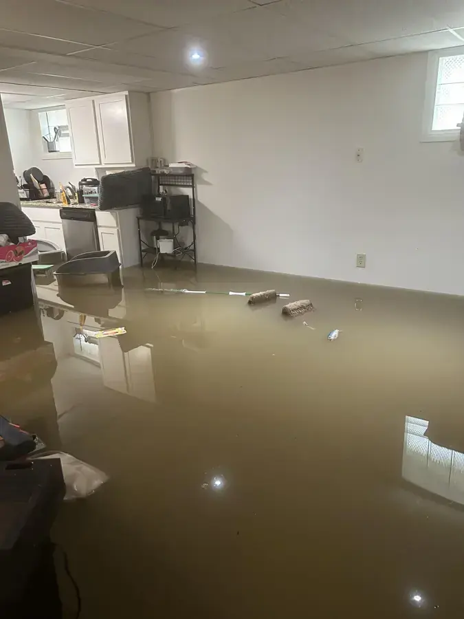 Standing water across a finished basement family room, a loss crews handle in South Jordan