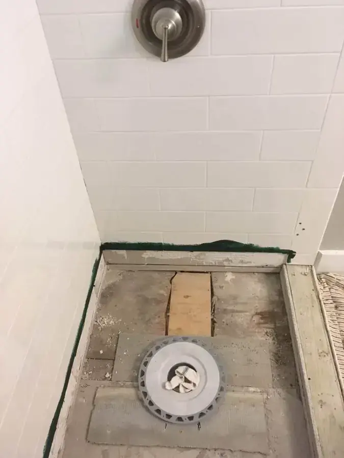 Leaking shower pan torn out down to the drain in a Riverton bathroom