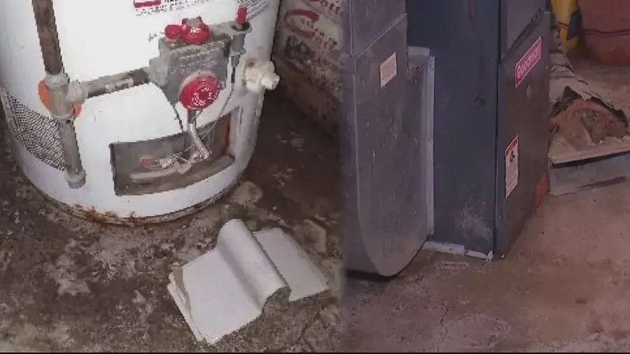 Corroded water heater beside the furnace in a Riverton basement utility room